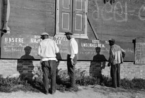 Collective farm workers at a street news board, 1933.