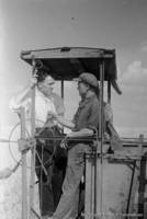I.I. Gerber, the director of the Krasny Yar MTS [Machine and Tractor Station] talking to K.J. Simon, a distinguished combine driver, 1940.